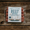 Packaged Beef Hot Dogs on a wooden table.