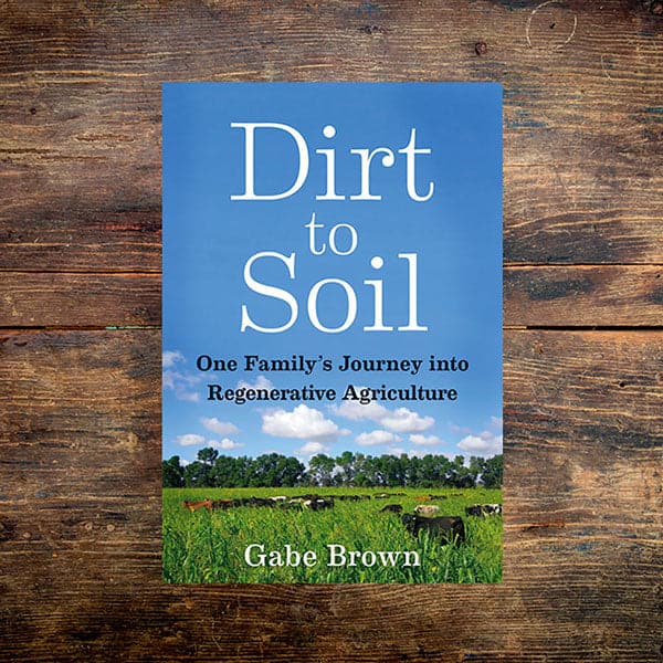 Dirt to Soil book on a wooden table.