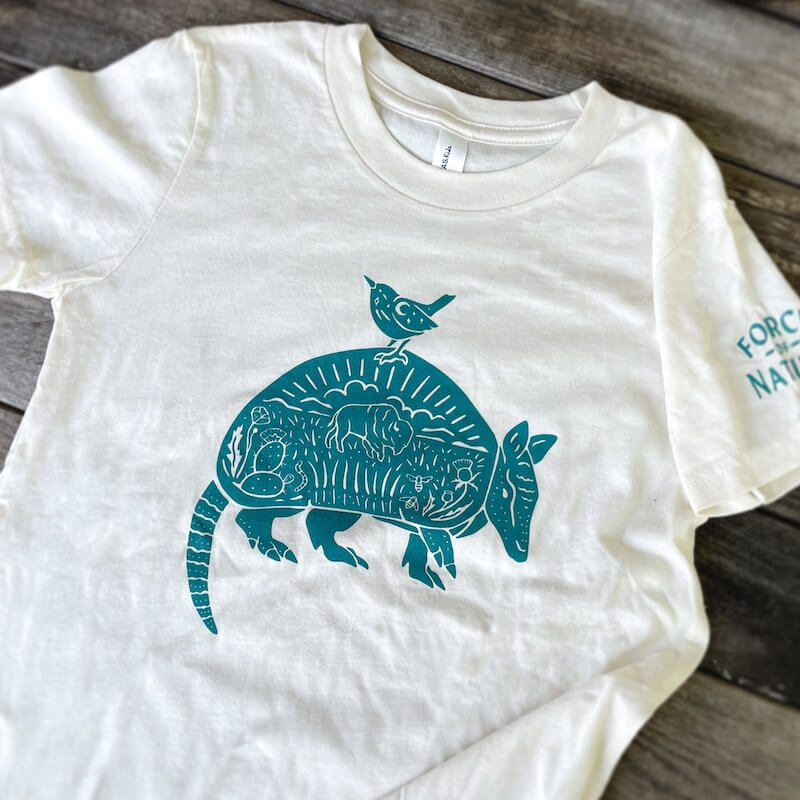 A white shirt with an armadillo on it.