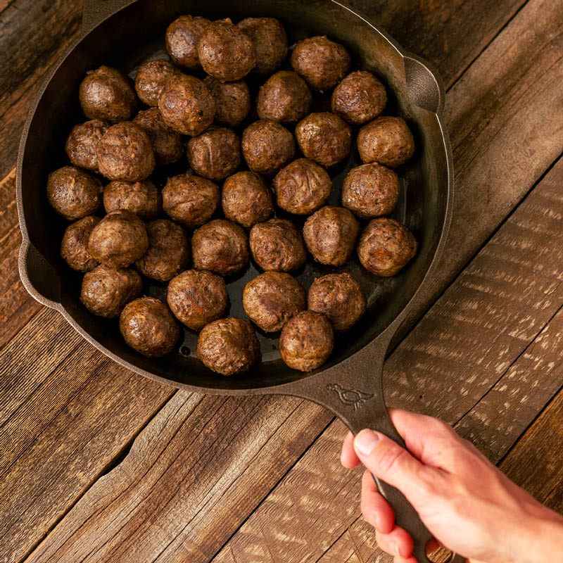 Meatballs in a cast iron skillet.