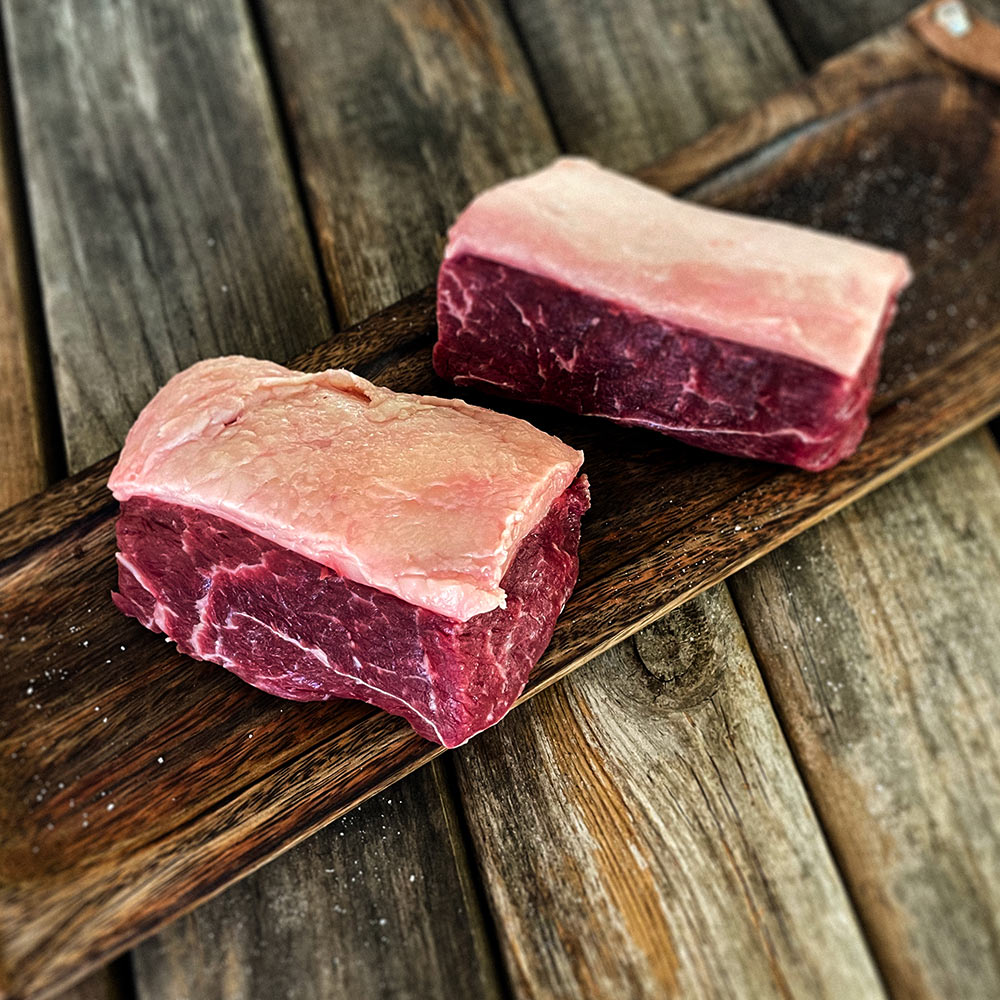 Raw Picanha steak on a cutting board.