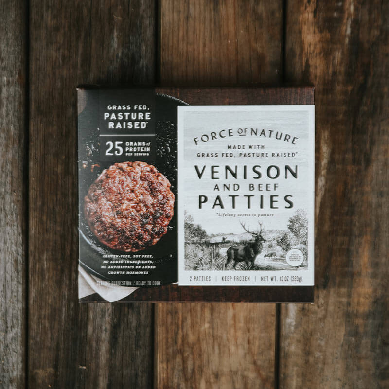 Venison and beef patties box on a wooden table.