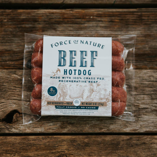 Packaged Beef Hot Dogs on a wooden table.