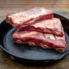 Bison Short Ribs stacked in a pan.