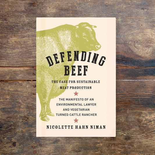 Defending Beef book on a wooden table.