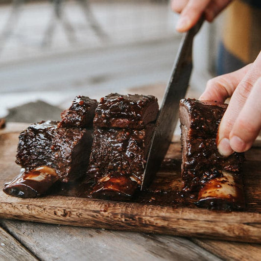 Bison Short Ribs sliced on a cutting board.