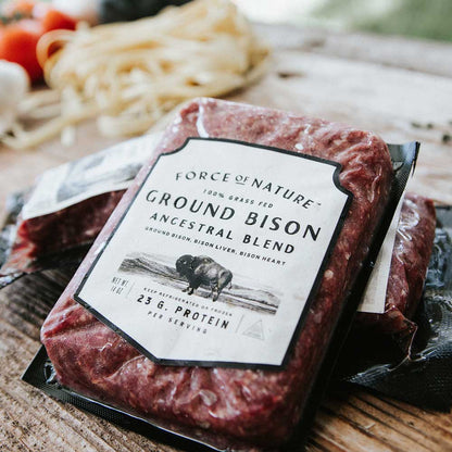 Package of ground bison on a wooden table.